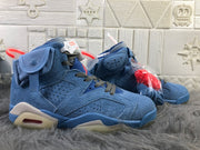 Side view of the sky blue high-top sneakers with perforated panels, ankle pocket details, and contrasting laces.
