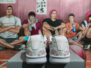 Rear view showing heel details and burgundy speckled accents on white Nike shoes