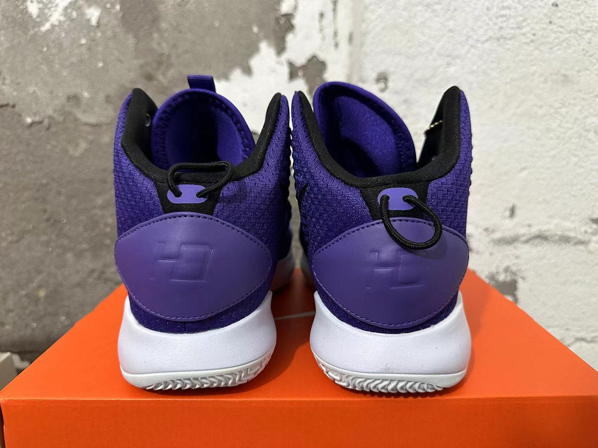 Rear view of purple high-top basketball shoes with white soles and black collar trim