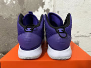 Rear view of purple high-top basketball shoes with white soles and black collar trim