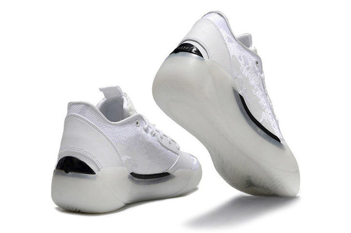 White Jordan low-top sneakers shown from the rear and outsole.