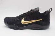 Side profile of a black Nike Kobe 11 shoe with a gold Swoosh.