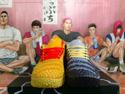 Front view of the mismatched yellow and blue basketball shoes with contrasting laces.