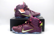 Pair of burgundy and pink high-top sneakers displayed with a black shoebox.