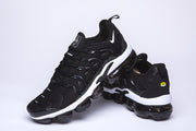 Pair of black and white Nike TN-10 sneakers, showing the front, sides, and heel.
