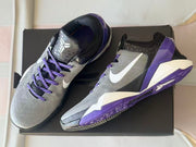 Angled top view highlighting the purple laces, tongue details, and side branding.