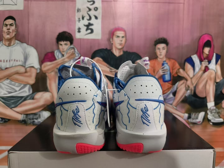 Rear view of white and blue Nike basketball sneakers showing blue collars, blue heel detailing, and pink outsole accents.