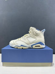 Profile view of one cream and blue high-top sneaker displayed on a blue box.