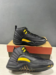Two black and yellow Jordan Air Jordan 12 Retro sneakers shown from angled side views with a Jordan shoebox.