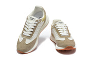Pair of taupe, white, and olive lace-up sneakers shown from the front