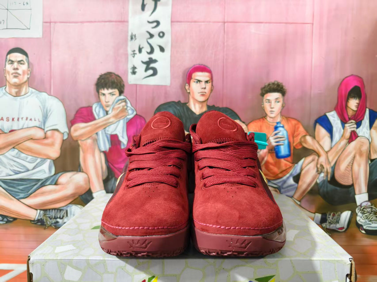 Front view of burgundy Nike basketball shoes with matching laces and embossed toe details