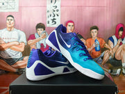 Pair of purple and blue Nike basketball sneakers displayed on a black box.
