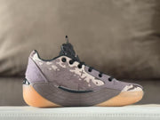 Side profile showing the patterned upper, sculpted gray side panel, and translucent amber-colored outsole.