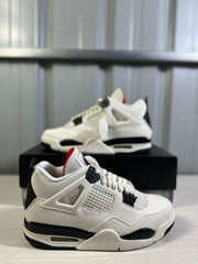Angled close-up of the white Air Jordan 4 upper, mesh panel, black lace supports, and midsole.