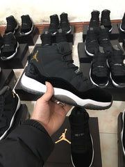 Side profile of a black high-top sneaker with gold-colored side branding, white midsole, and translucent outsole.