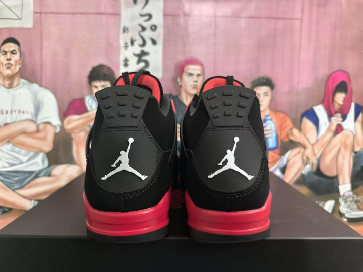 Rear view of black and red Jordan 4-style sneakers with white Jumpman logos and red midsoles.