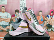 Angled view of both pale pink and silver Nike basketball shoes