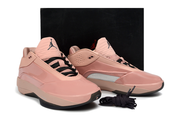 Pair of dusty pink Jordan 40 sneakers displayed in front of a black box.