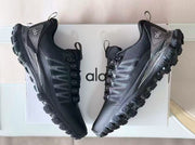 Top and side view of a pair of black Alo sneakers showing the lace system, padded collars, and textured panels.