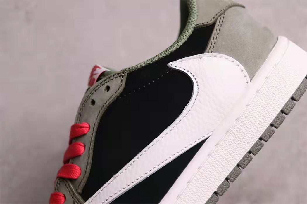 Close-up of the black and grey upper with a large white side Swoosh, red laces, and white midsole.