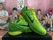 Angled view of a pair of green Nike Kobe basketball shoes with textured uppers