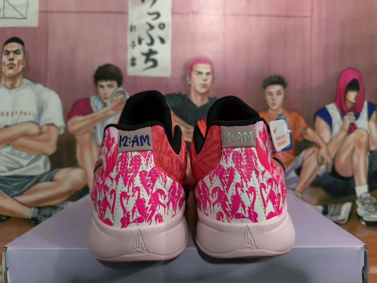 Rear view of coral pink Nike basketball sneakers with patterned pink heel panels and black collar lining.