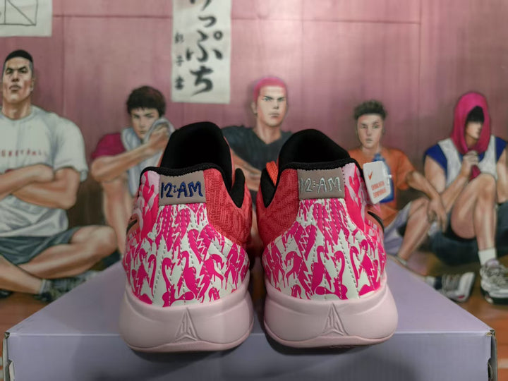 Rear view of coral pink Nike basketball sneakers with patterned pink heel panels and black collar lining.