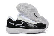 Side and outsole views of black and white Nike G.T. Cut Academy shoes.