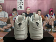 Rear view of the white high-top sneakers showing padded heels, pull tabs, and black logo details.