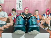 Rear view showing GT heel badges and pale outsoles on metallic aqua-teal basketball shoes