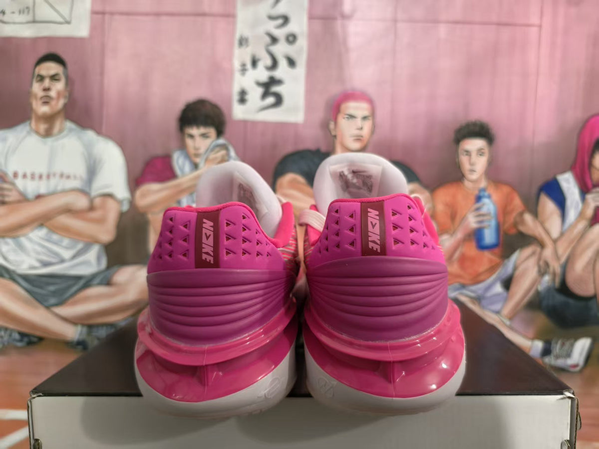 Rear view of pink and white Nike basketball sneakers displayed on a shoe box.
