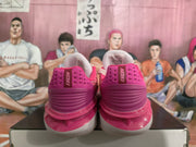 Rear view of pink and white Nike basketball sneakers displayed on a shoe box.