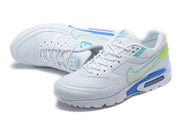 Pair of white Nike Air Max sneakers with turquoise accents and blue air-unit details.