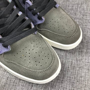 Close-up of the gray perforated toe panels and black woven laces.