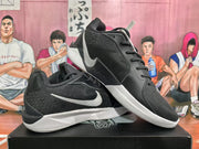 Angled view of black and white Nike basketball sneakers displayed together on a shoebox.