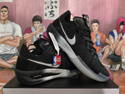 Angled view showing black Nike shoes with silver Swooshes and translucent outsoles.