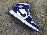 Side profile of one white and blue mid-top sneaker with a blue Swoosh and layered panels.