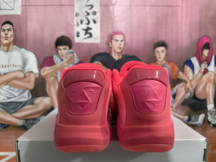 Rear view of a pair of pink Jordan basketball sneakers showing padded heel sections and Jumpman-style detailing against an illustrated backdrop.