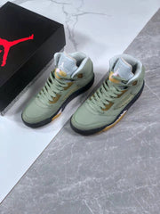 Pair of green Jordan Air Jordan 5 sneakers shown beside a black Jordan shoe box.