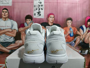 Rear view of the pair showing padded collars, sculpted white heels, and gold signature-style heel artwork.