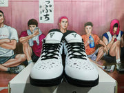 Front view showing the white toe boxes, black laces, speckled pattern, and black outsoles.
