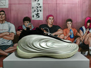Side view highlighting the layered, wave-like cream panels of the basketball shoe.