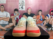 Front view of the lace-up basketball shoes with cream laces, coral toe accents, and gum-colored outsoles.