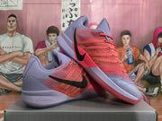 Angled view showing the coral laces, black Swoosh, and lavender panels.