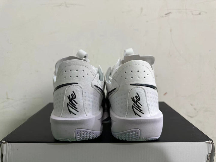 Rear view of white basketball shoes with black heel accents and perforated panels.
