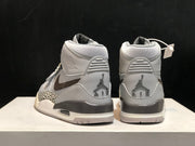 Rear view of the pair showing Jordan heel graphics, grey heel panels and layered soles.