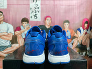 Rear view of the blue sneakers showing padded collars, white midsoles and red signature-style heel details.