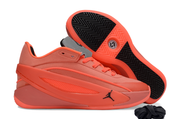 Bright red sneaker shown in side profile beside an upturned shoe displaying the patterned outsole.