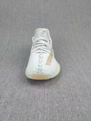 Front view showing the lace-up construction, rounded toe, and pale gray upper.
