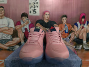 Front view of pink Nike sneakers showing mesh uppers, pink laces, dark gray collars, and translucent-looking soles.